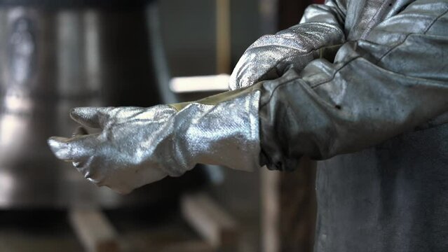 Bell Casting Foundry Worker Putting on Heat Resistant Gloves SLOMO
