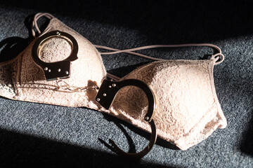 Handcuffs for sex games and bra. Sexual bdsm toy. Fetish, erotic concept.