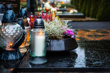 All Saints' Day and burning candles and flowers on the graves.Candles on graves symbolize the...