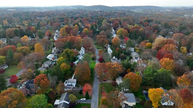 New England town in autumn. Residential community in American suburbs. Fall leaves and colorful foliage.