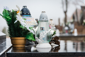 All Saints' Day.candles and flowers on the graves.Candles on graves symbolize the memory of the dead on November 1.Catholic cemetery during All Saints' Day.Selective focus.