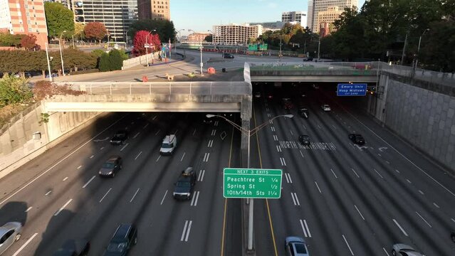 Interstate 85 traffic to Peachtree Georgia. Emory University exit in Atlanta. Aerial at golden hour.