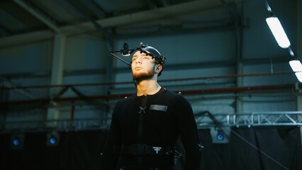 BTS Actor wearing motion capture suit acting as a game or animation movie character. Motion capture...