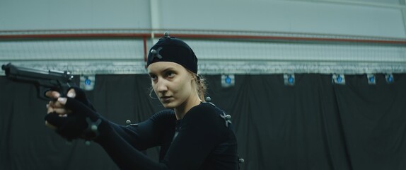 BTS Female actor wearing motion capture suit acting as a game or animation movie character. Motion capture is an unparalleled method for making animated characters move more realistically
