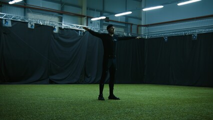 BTS of filmmaking. Actor is standing in T-pose for calibrating motion capture software. Motion...