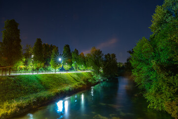 A river next to the highway at night in Pordenone, Italt