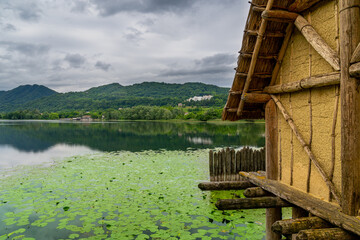 A hut next to a lake in an archaeological site in Lago di lago, Italy