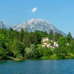 A small village in the forest at the foot of a mountain next to a river in Barcis, Italy