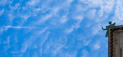 Landmark in VOLKSGARTEN with a plane flying in the sky in Vienna, Austria