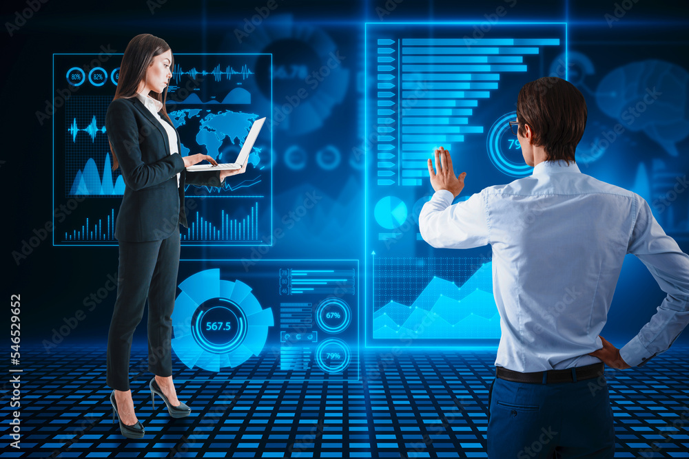 Poster back view of attractive young businessman using abstract glowing blue business charts and graphs hol