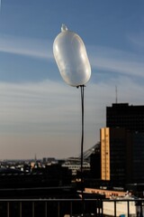 Verticaal schot van een opgeblazen drijvend condoom in de lucht in Berlijn
