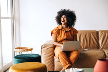 Thoughtful young businesswoman looking away with a smile