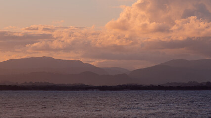 Fototapeta premium Sunset view of mountain layers on the coast.