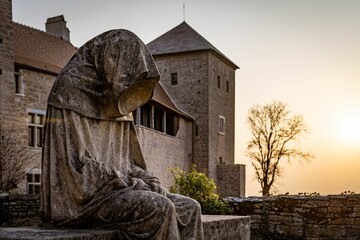 Beautiful shot of a hooded stone statue in the Chateau de Gevrey Chambertin, in Burgundy, France