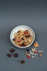 A bowl of muesli on a gray monochrome background, healthy food, healthy breakfast