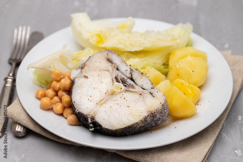 Sticker baked vegetables with boiled fish on white plate