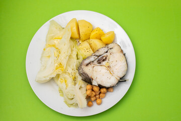 baked vegetables with boiled fish on white plate
