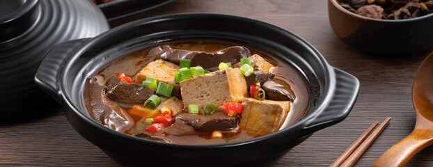 Spicy duck blood jelly soup and stinky tofu with scallion and chili pepper topping.