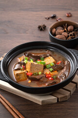 Spicy duck blood jelly soup and stinky tofu with scallion and chili pepper topping.