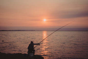 fisherman at sunset in the ebro delta