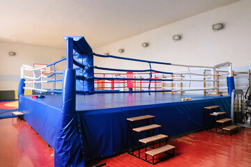 Quadrangular boxing ring on the platform in the gym