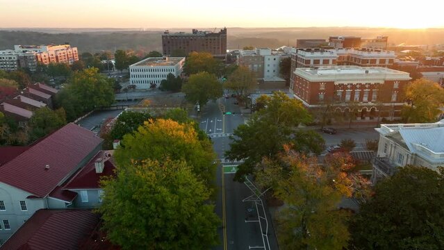 Beautiful aerial pullback reveal of downtown Athens Georgia City Hall and historic antebellum architecture. Golden hour light. Establishing shot for Athens GA USA.