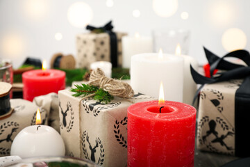 Concept of Happy New Year, gift boxes and candles, blurred background