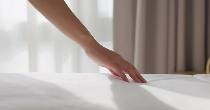 woman hand on bed