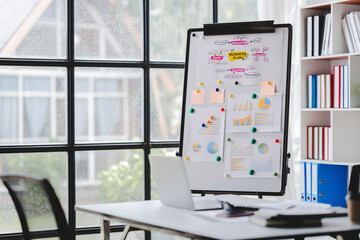 Empty workspace, no people, office desk, with laptop, calculator, graphs, documents on the table.