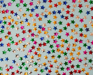 Pattern made of stars confetti on blue background. Flat lay concept. Parti time.