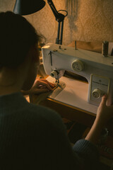 The girl sews on a sewing machine, High quality