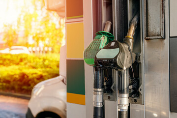 Colorful petrol and diesel nozzles of the dispenser machine at the gas fuel station