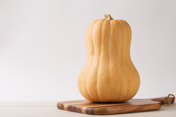 Butternut squash on a white rustic wood table providing copy space. Harvest. Fall time....