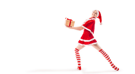 Dancing ballerina with a box of gifts in her hands on pointe shoes in Santa Claus costume isolated...