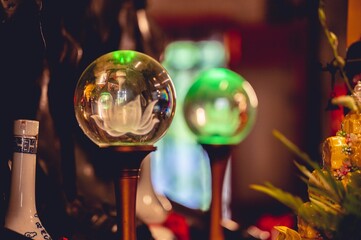 Closeup shot of glass orb decorations on a Buddhist temple altar in Vietnam