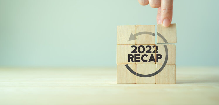 2022 Recap economy, business, financial concept. For business planning. RECAP word icon on wooden cubes on smart grey background and copy space..