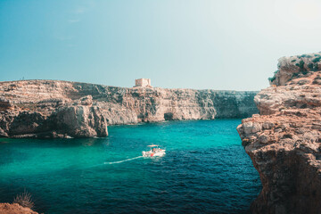 small boat in a cyan lake of an island of malta