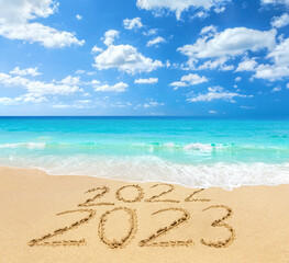 Fototapeta premium 2022 and 2023 on a beach sand