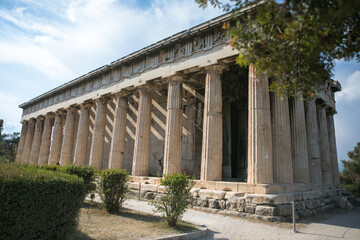 Temple of Hephaestus in Athens, Greece. Sunny view of Ancient Greek ruins in the Athens center. The Famous Hephaistos temple on the Agora in Athens, the capital of Greece.