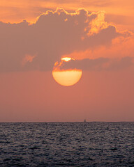 ship on the horizon as the sun goes down