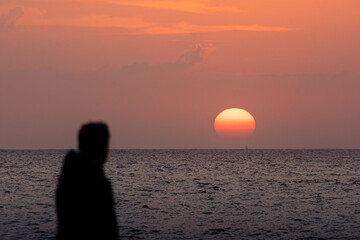 person watching the sunset on a beach