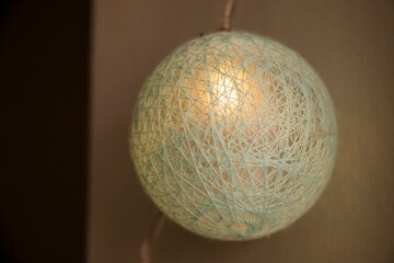 Closeup shot of a beautiful round lantern light on a string
