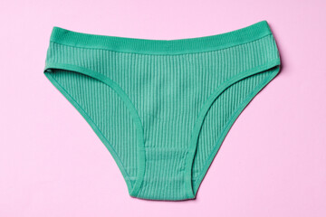 Women's panties on pink background with copy space