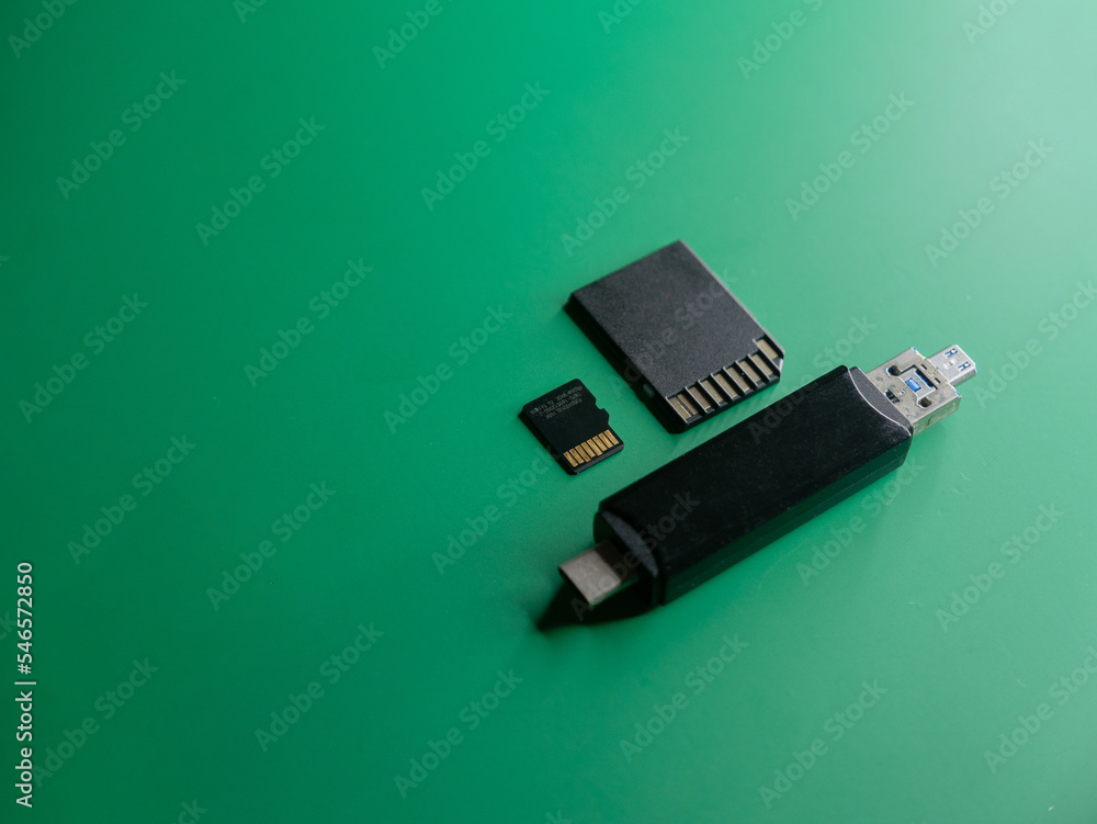 Poster memory cards with a card reader on a green background top view