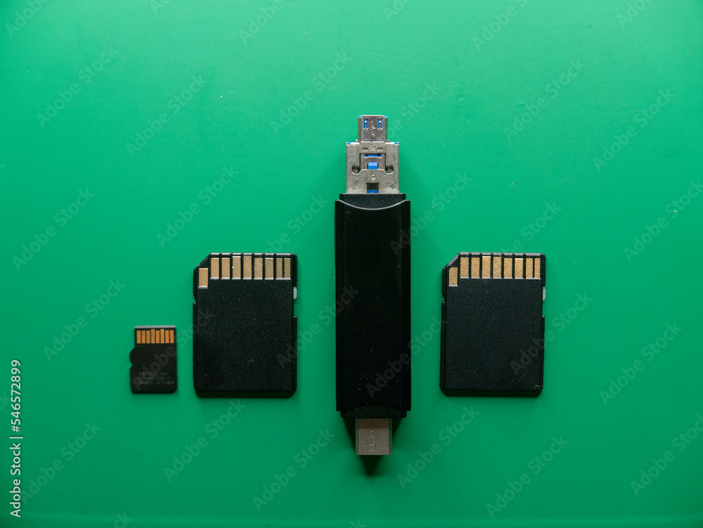 Poster memory cards with a card reader on a green background top view