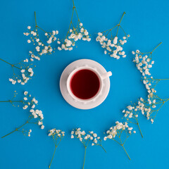 Herbal tea with one white tea cups with white flowers Flat lay, top view. Tea concept