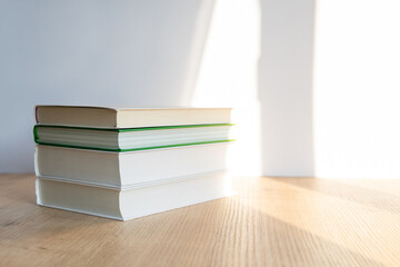 books on a wooden table. a stack of books on a white background.
