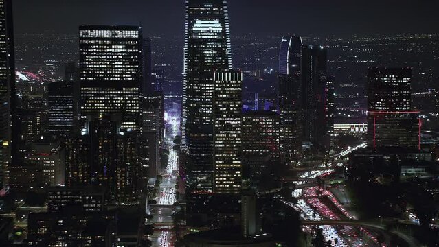 
Beautiful Shot of Big City at Night Illuminated Skyscrapers. Aerial view of Downtown Los Angeles. Blurred brands and Logos. Shot on helicopter.