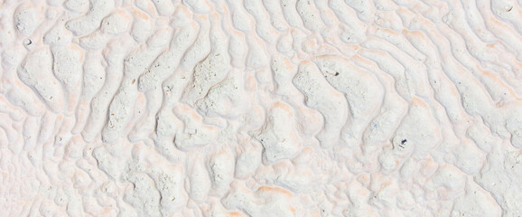 White volcanic limestone rock as background.
