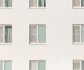 Fototapeta na wymiar Windows in a white multi-storey building